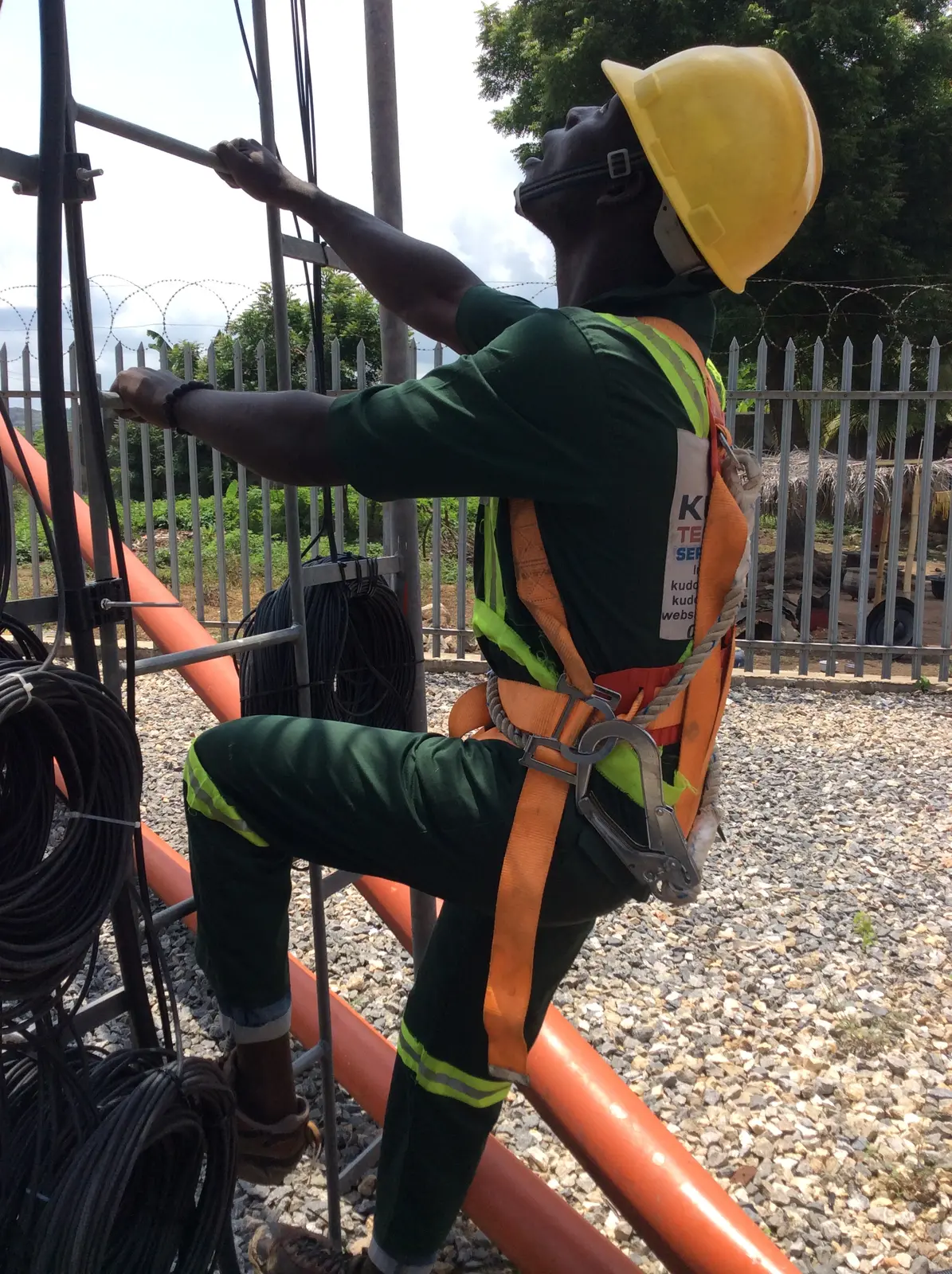 Kudos technician installing cable at a telecommunications tower site